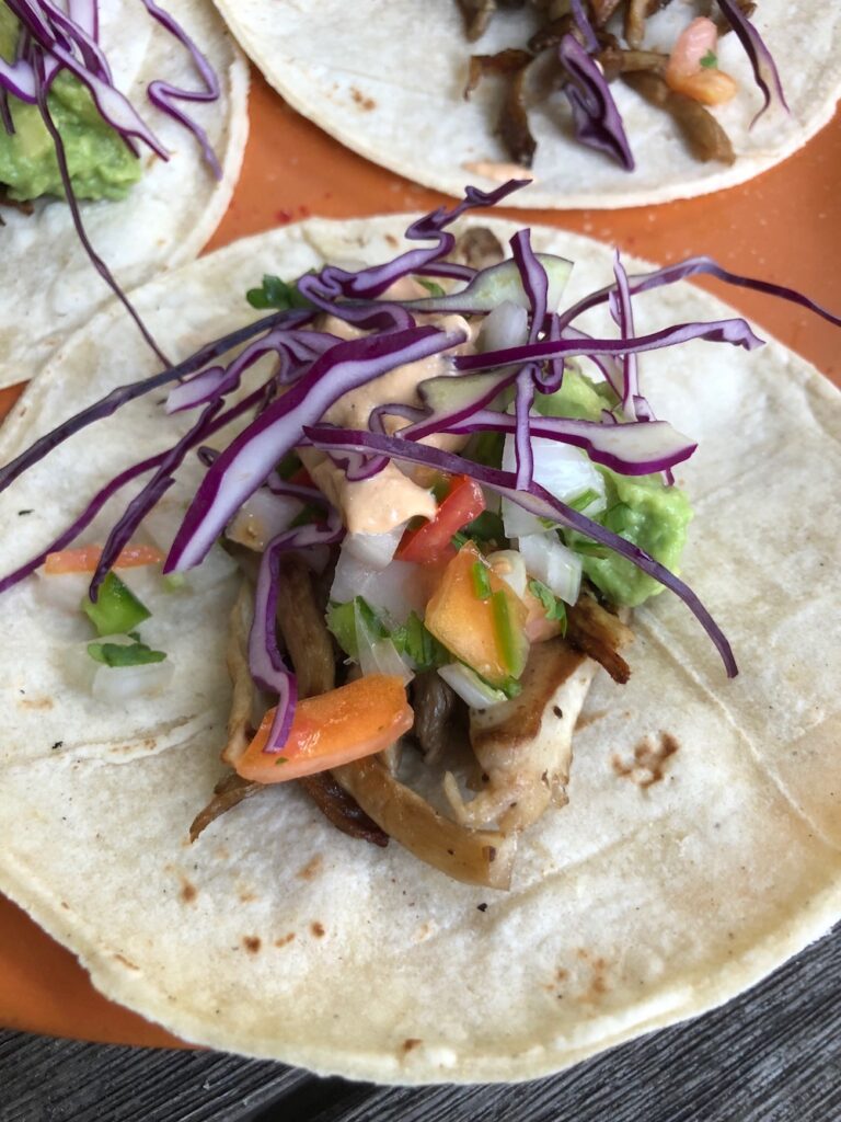 Oyster mushroom tacos with purple cabbage, pico salsa, guacamole and Vegan Chipotle Crem