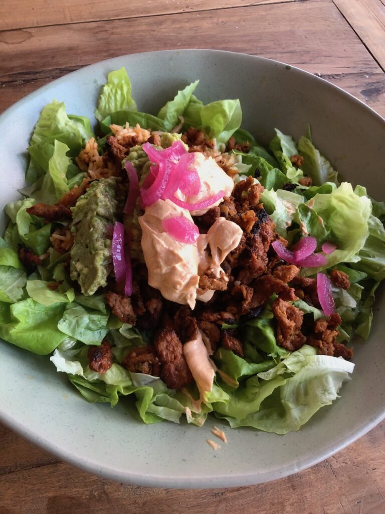 Vegan chicken al pastor salad with a dallop of Vegan Chipotle Crema.