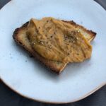 roasted vegetable dip served on a piece of toast