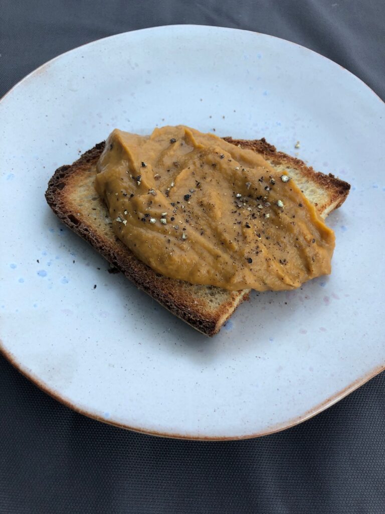 roasted vegetable dip on a piece of toast.