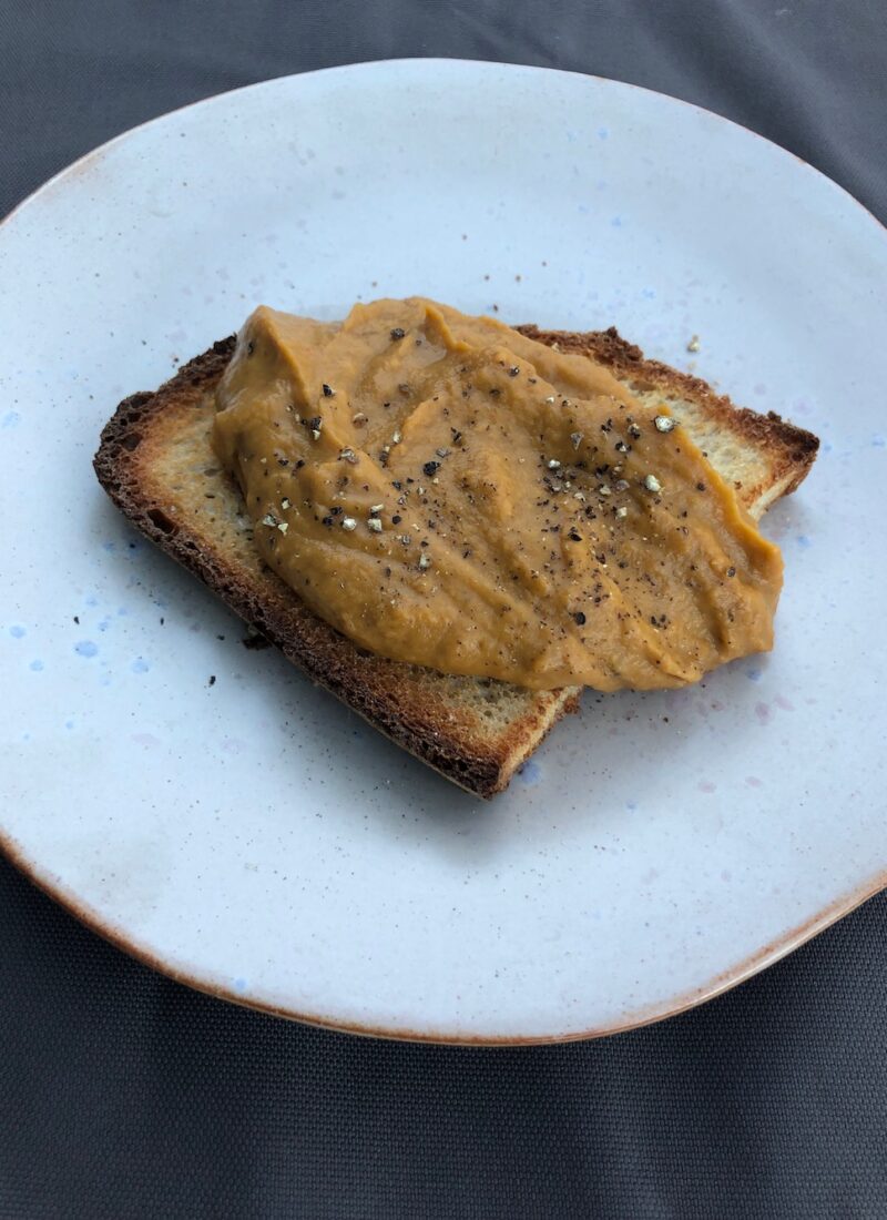 roasted vegetable dip on a piece of toast.