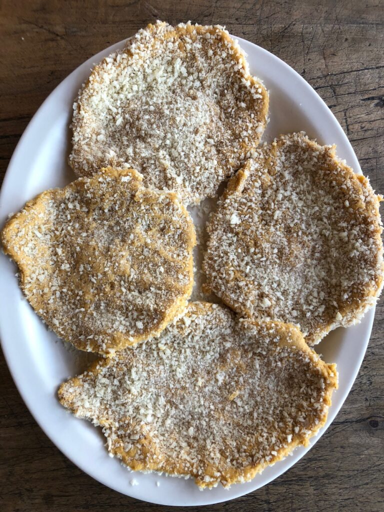 Chickpea cutlets breaded and ready to fry