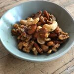 sweet, savory and spicy nuts in a small serving bowl.