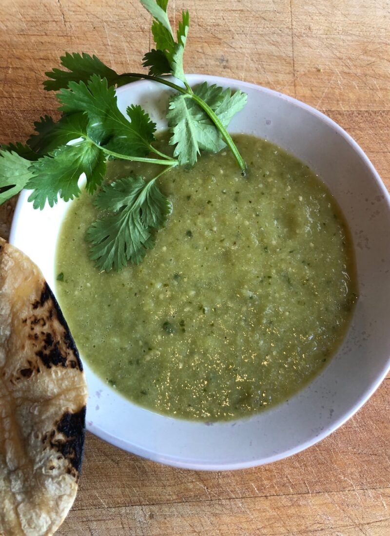 Tomatillo salsa in a small bowl and garnished with cilantro.