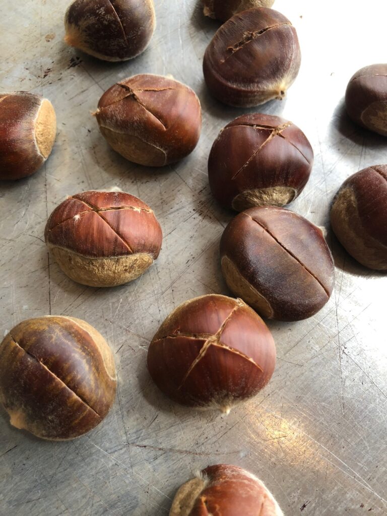 Chestnuts on a Baking Sheet ready to Roast in the Oven.