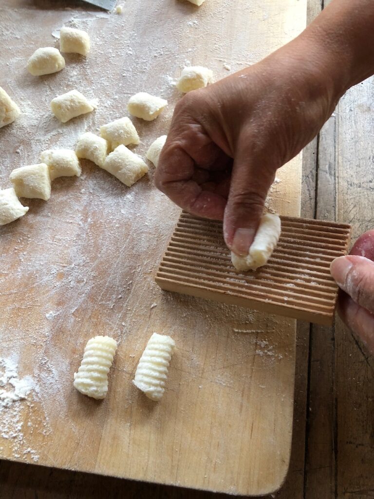 Holding the gnocchi and gently applying pressure