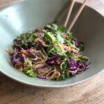 Vegan ramen noodle salad served in a bowl with chopsticks.