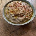 Brown lentil hummus dip in a small serving bowl.