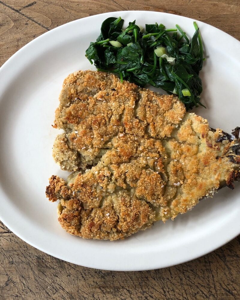 Breaded eggplant served on a dinner plate.